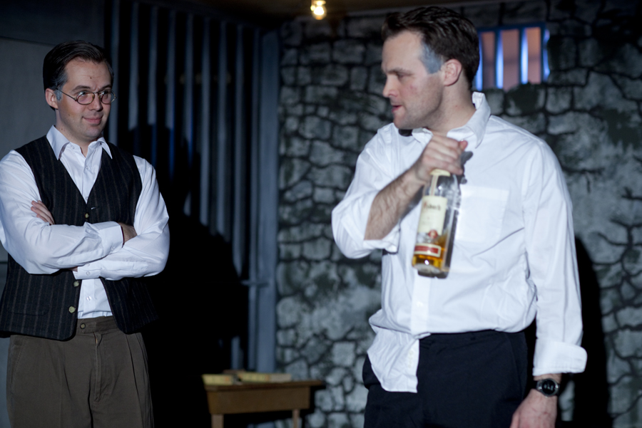 Bonhoeffer (Chase Byrd) amused by the vicio. us Rott (Steve Underwood) getting drunk. Photo by  by © James Jackson.