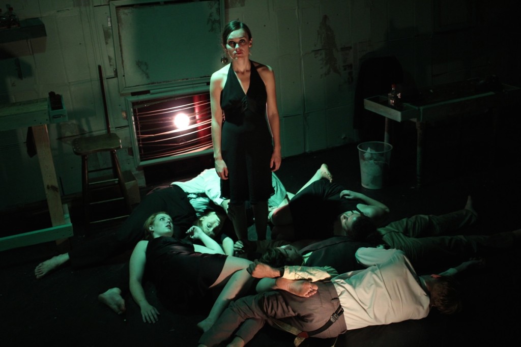 Phoebe Schaub as Charon (standing) and the ensemble of Found’s CITY OF WOES